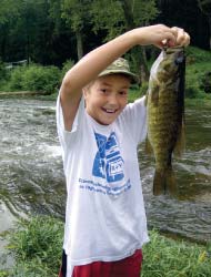 Boy holding a big fish.